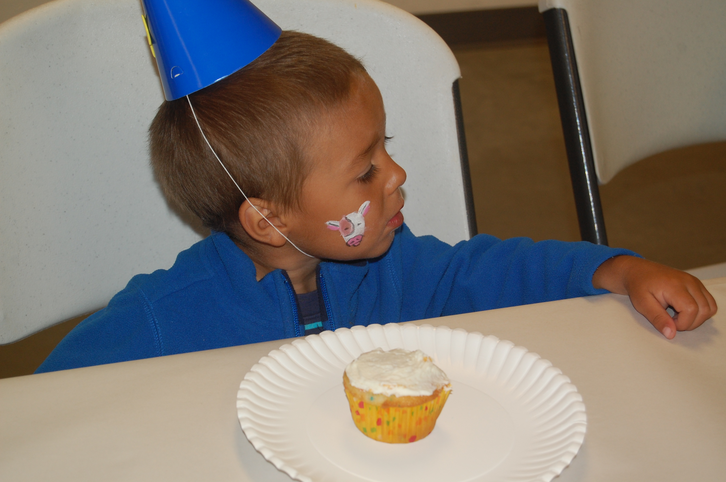 Ry waiting to decorate his cupcake