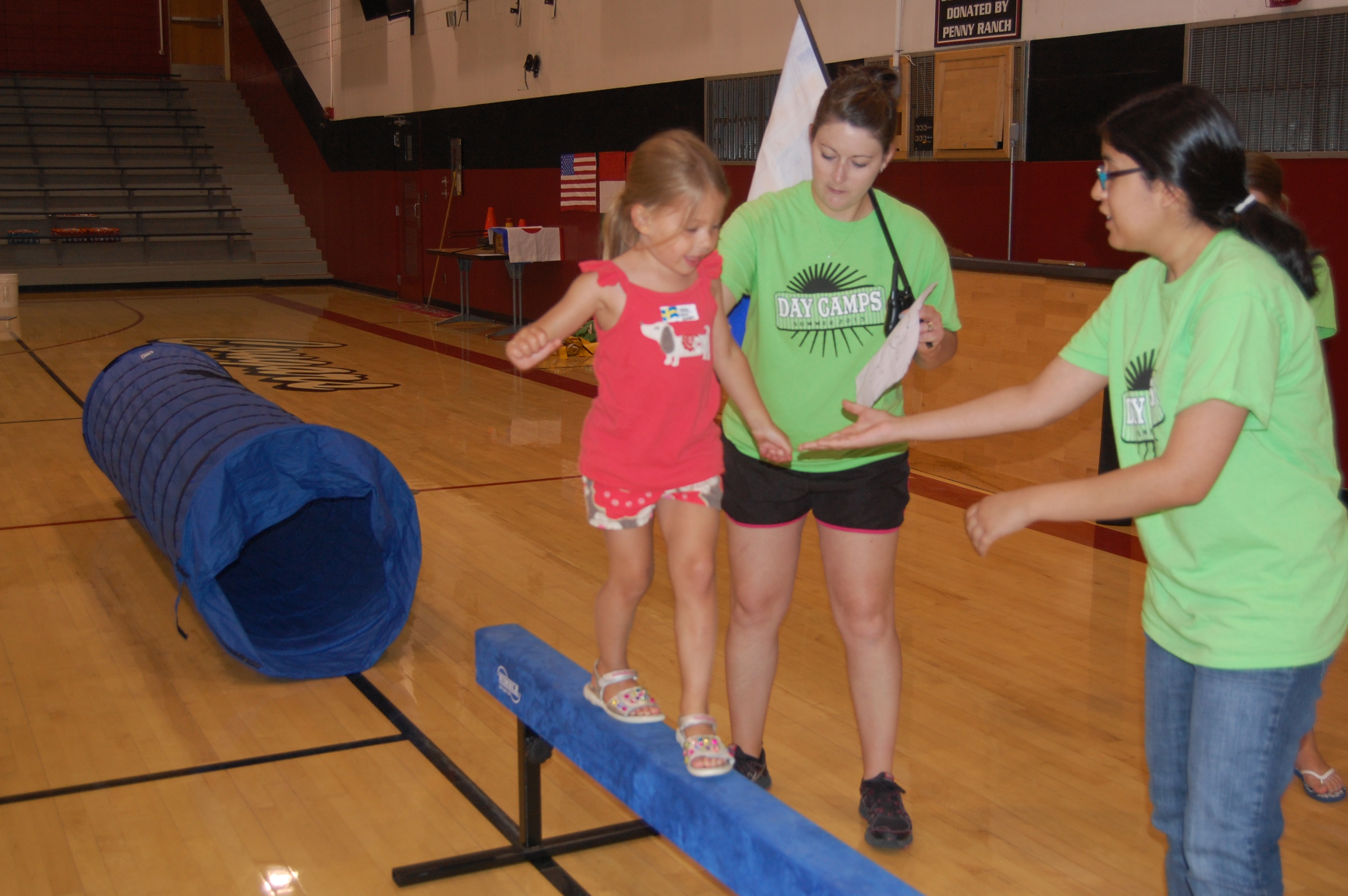 Shari and Joslyn helping Leah on the balance beam